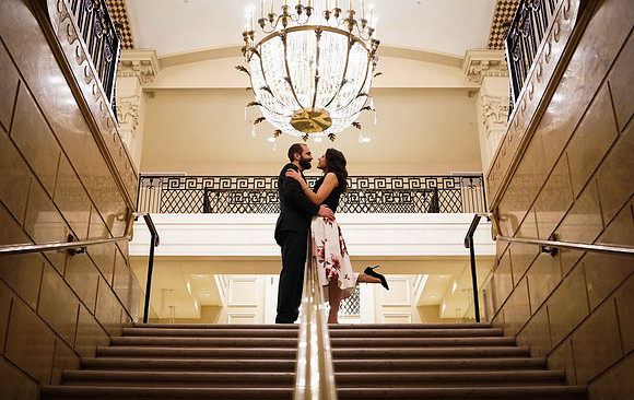 Elegant elopement with chandelier in hotel staircase